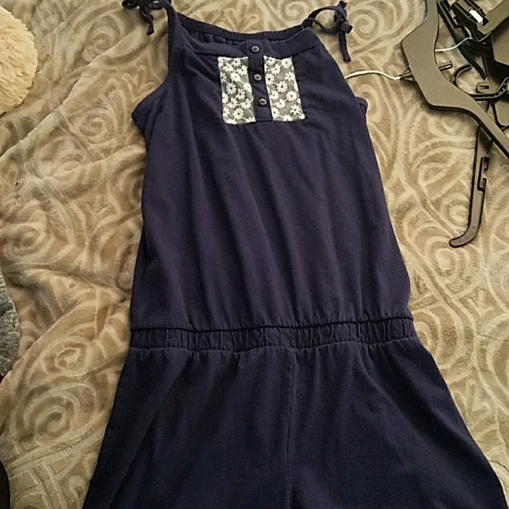 A dark blue romper with white flower designs